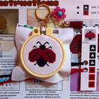 Stitch Em All bundle cross stitch kit contents with keychains, bookmarks, and luggage tags by Jumpseat Therapy