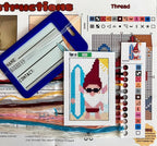 Cross-stitch pattern with a gnome character on a computer screen with design software.