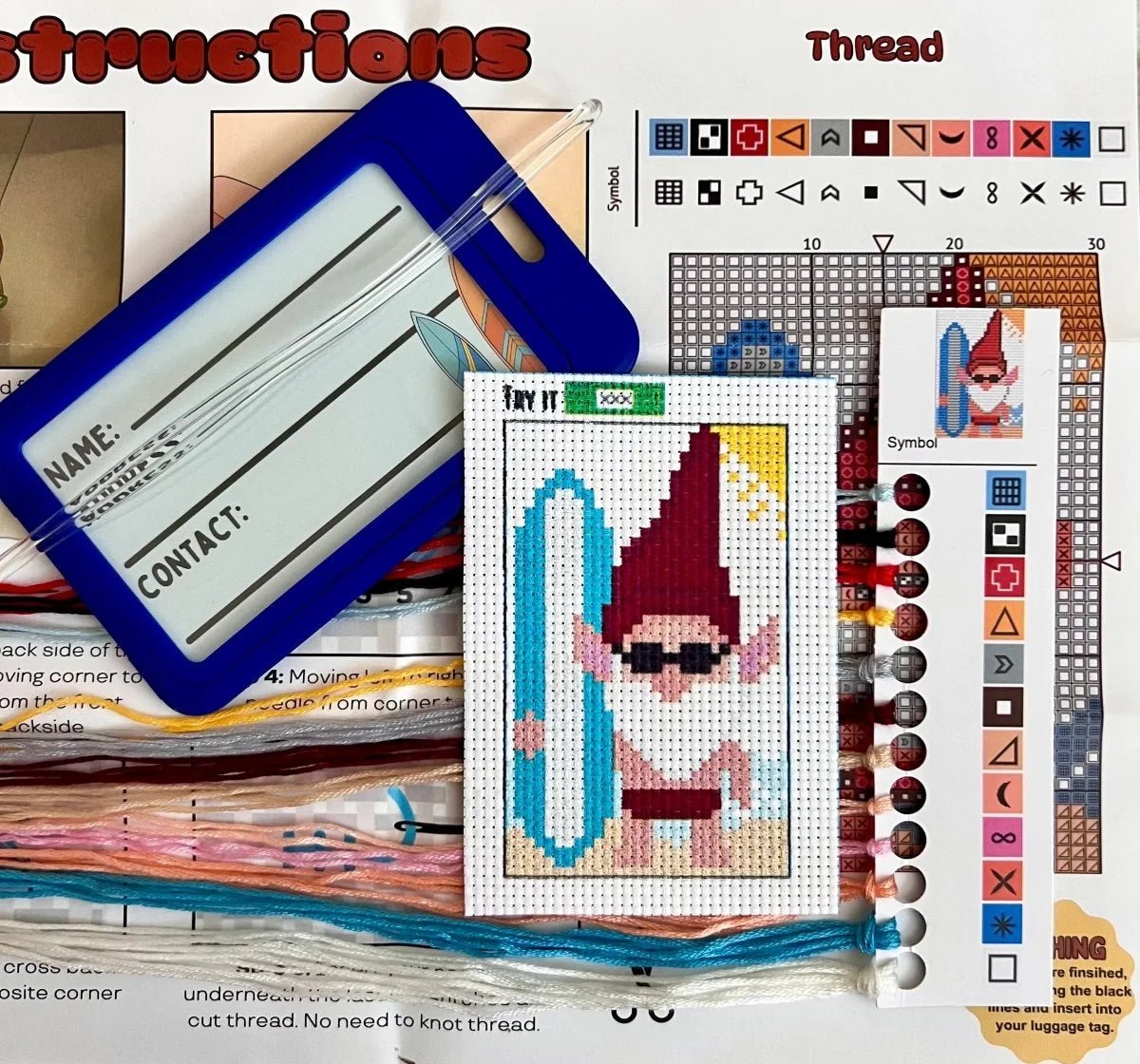 Cross-stitch pattern with a gnome character on a computer screen with design software.