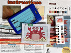 Cross-stitching kit with pattern, thread colors, and instructions on a table.