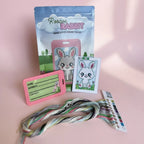 Roscoe the Rabbit cross stitch luggage tag kit — beginner-friendly contents on display