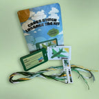 Green Airplane cross stitch luggage tag kit — beginner-friendly stamped fabric and supplies