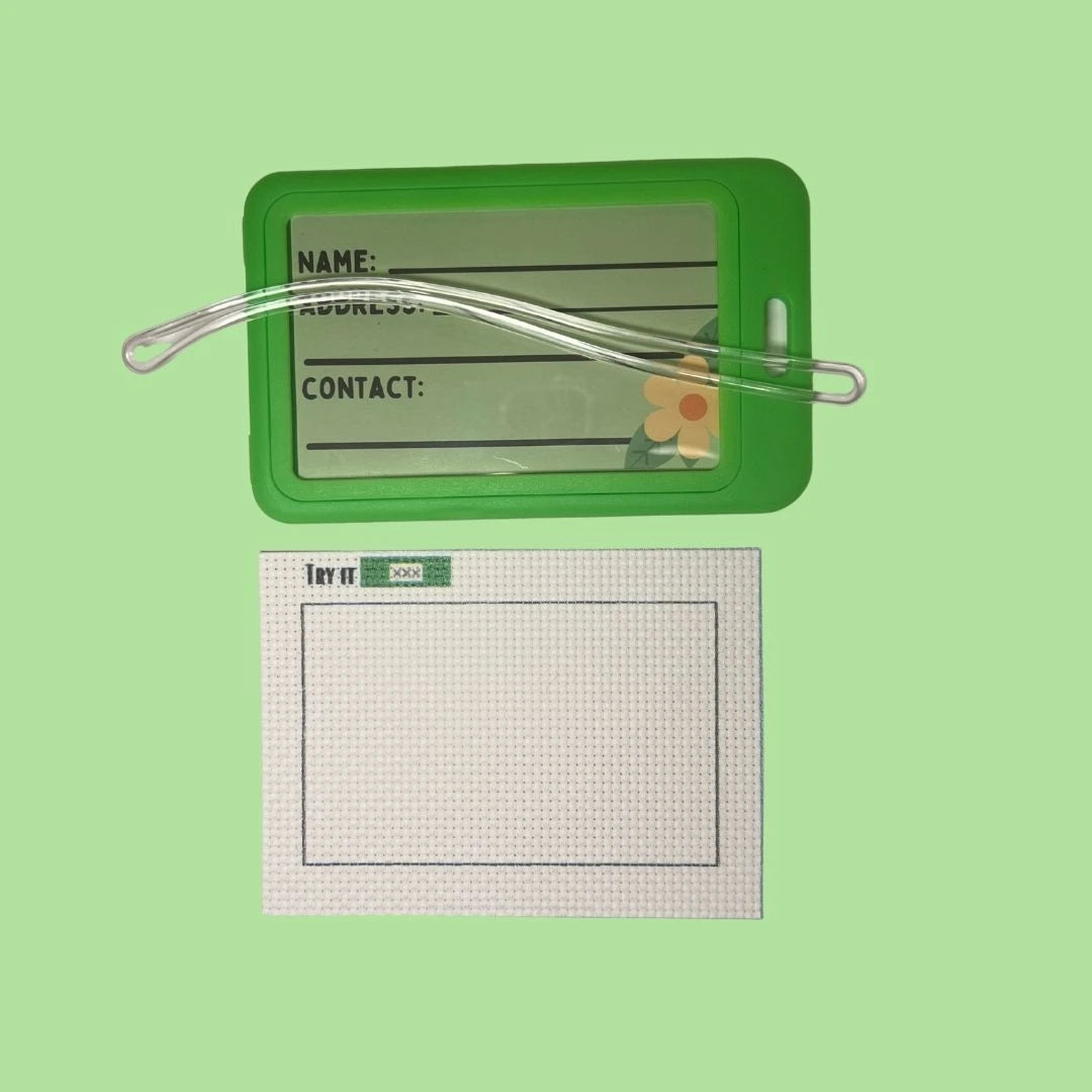 Green luggage tag with clear holder and 14CT Aida fabric  on a green background