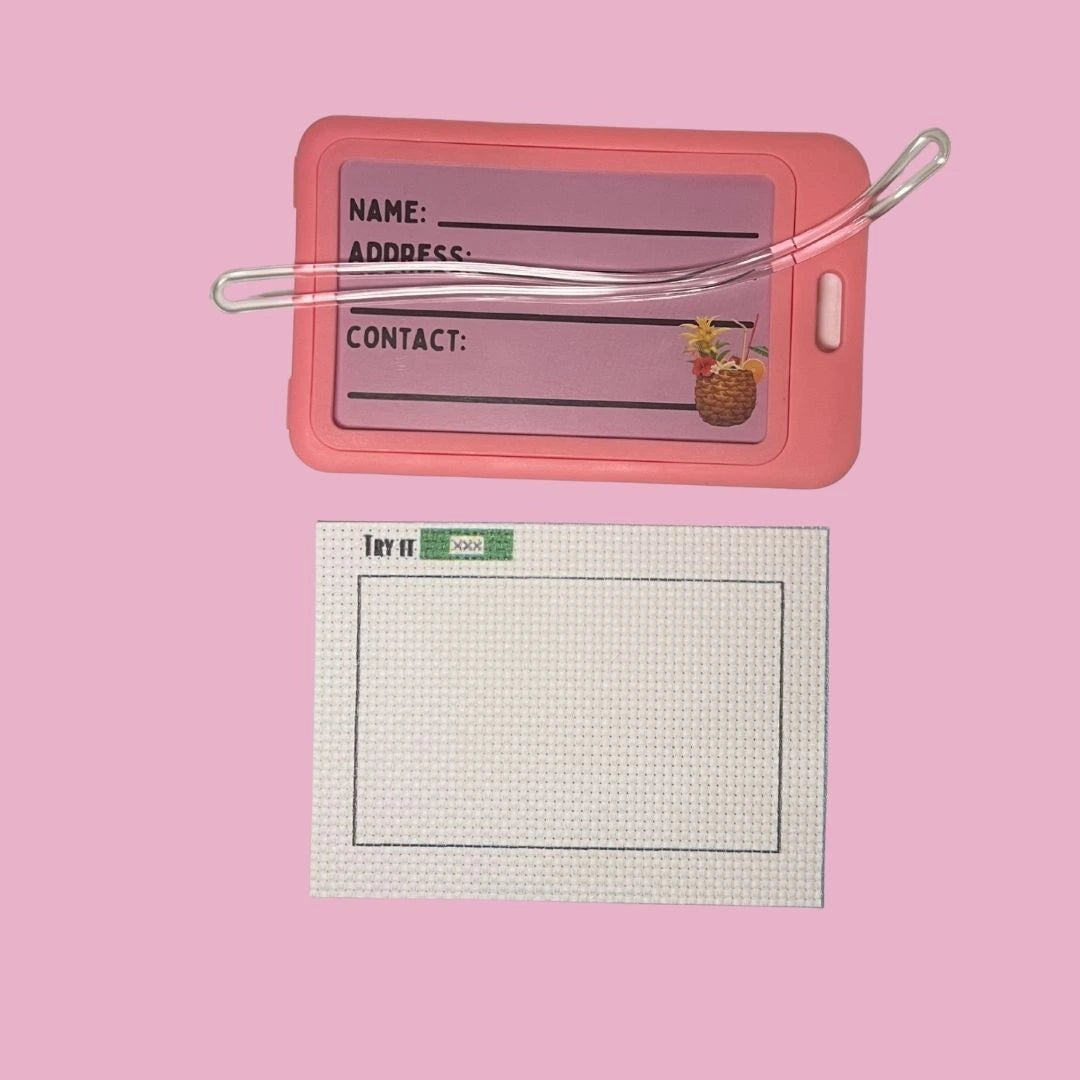 Pink luggage tag with a pineapple charm on a pink background and 14CT AIDA fabric