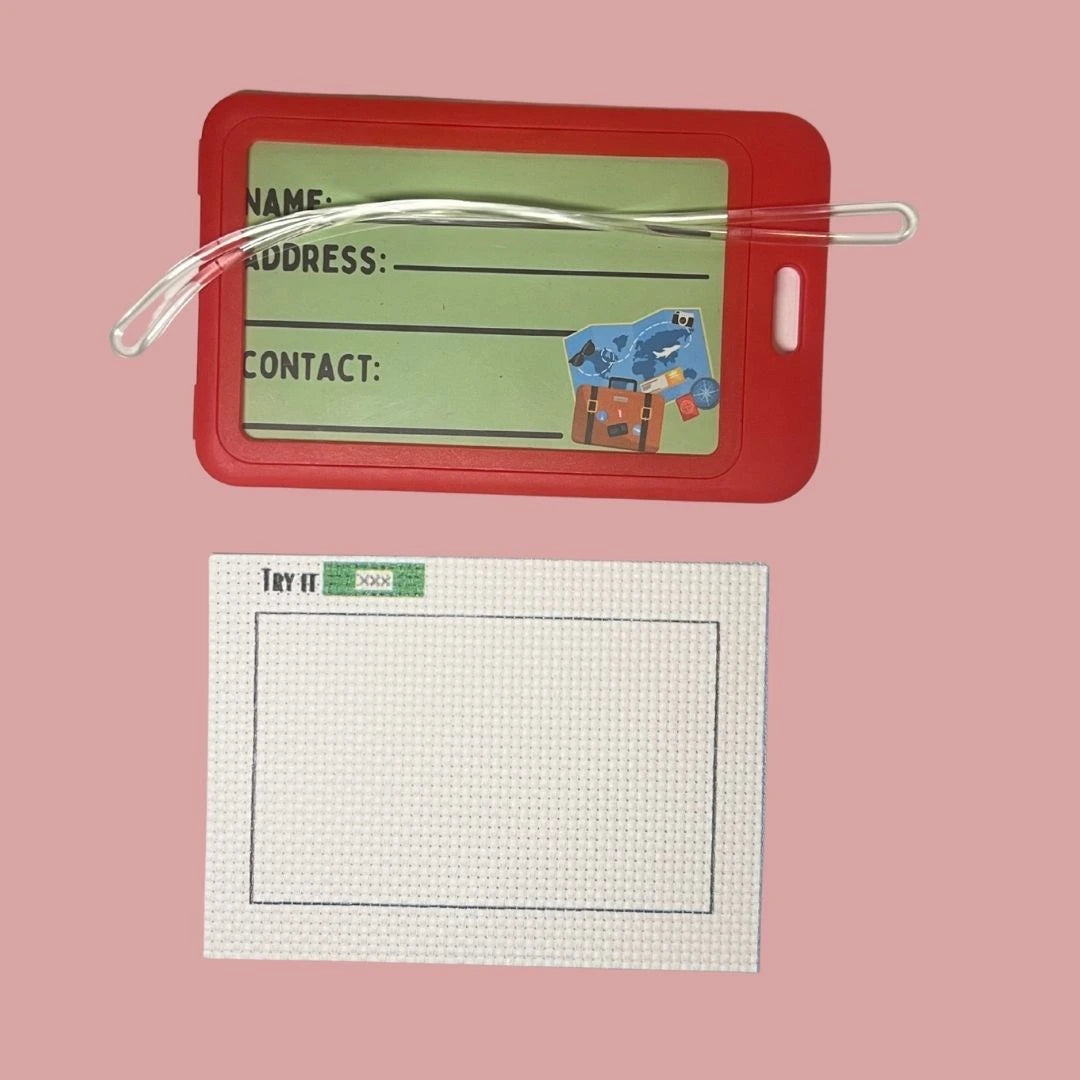 Red luggage tag with a 14 CT AIDA fabric  on a pink background