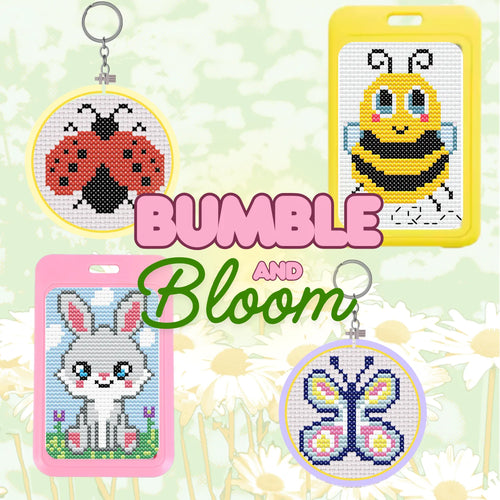 Cross-stitch keychains and cards with cartoon designs on a floral background, featuring the brand 'Bumble and Bloom'.