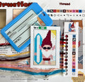 Cross-stitching kit with a gnome design, thread, and pattern guide on a white background.