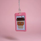 Cross-stitched character in a pink frame on a pink background