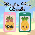 Two pineapple-themed cross-stitch kits with pink and green frames on a beach background.