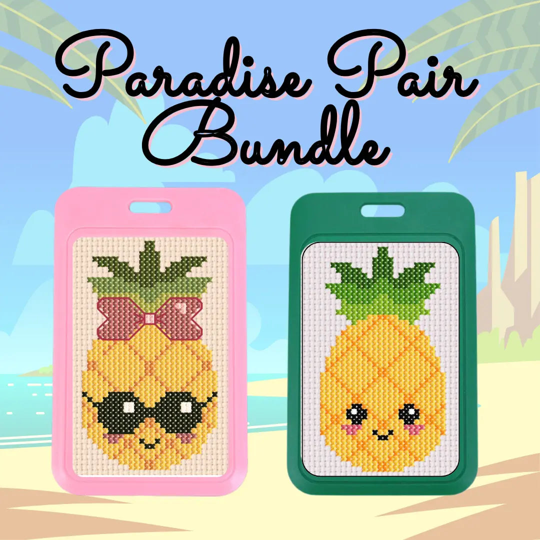 Two pineapple-themed cross-stitch kits with pink and green frames on a beach background.