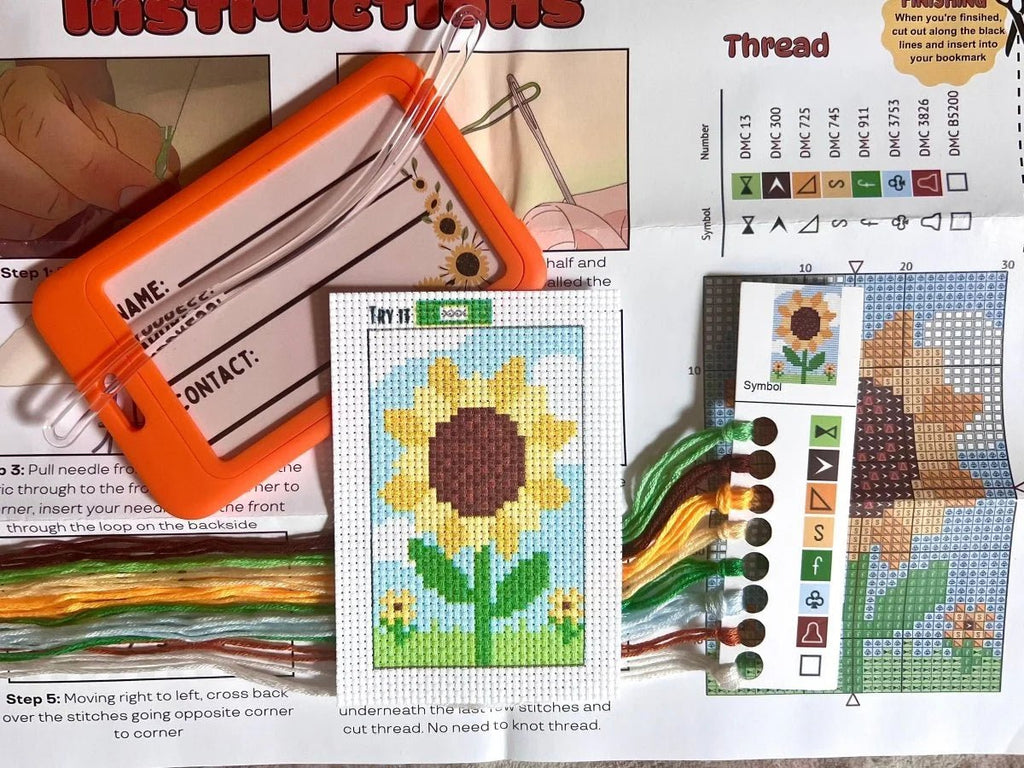 Cross-stitching kit with sunflower design, thread chart, and instructions.