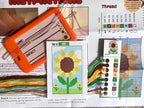 Cross-stitching kit with sunflower design, thread chart, and instructions.